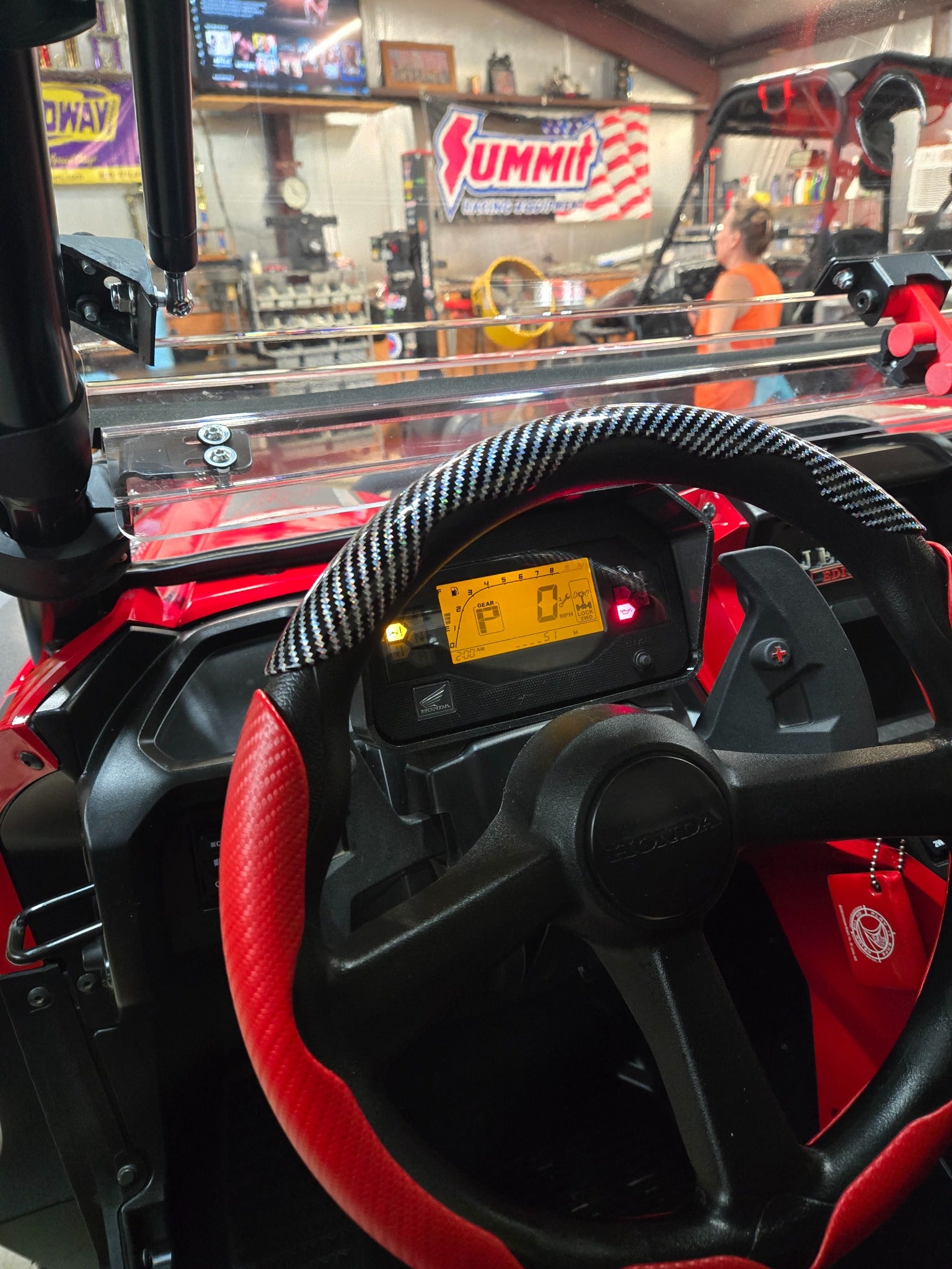 Gauge relocation kit installed in a red Honda Talon